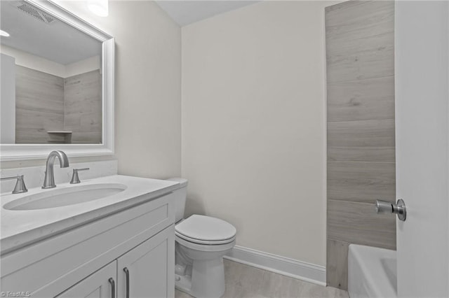 full bathroom with vanity, baseboards, toilet, a washtub, and visible vents