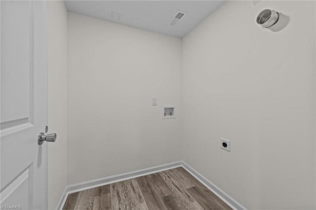 laundry room featuring electric dryer hookup, washer hookup, visible vents, laundry area, and wood finished floors