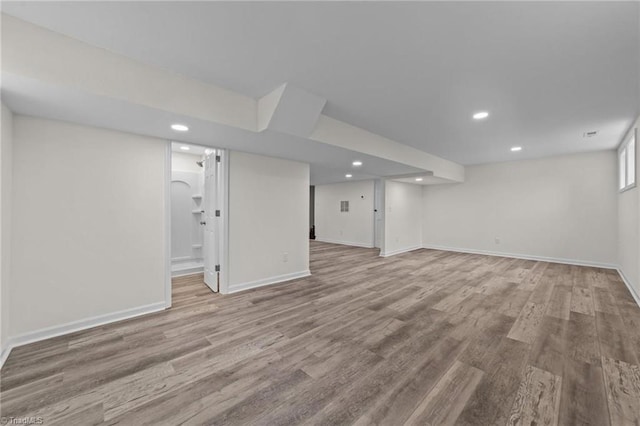 basement with baseboards, recessed lighting, and wood finished floors