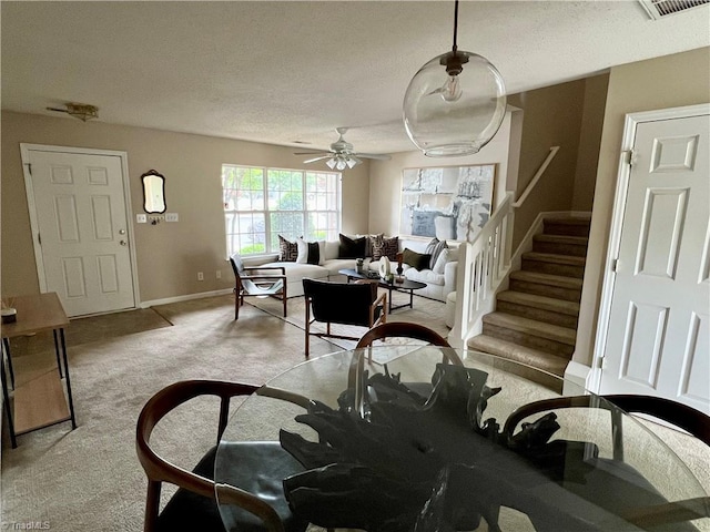 88 Tannenbaum Cir, Greensboro, NC 27410 - dining space with light colored carpet, stairs, baseboards, ceiling fan, and a textured ceiling