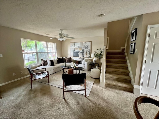 88 Tannenbaum Cir, Greensboro, NC 27410 - carpeted living room featuring a textured ceiling, ceiling fan, stairs, and baseboards