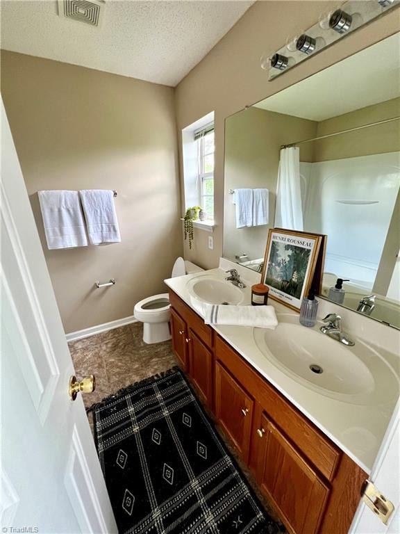 88 Tannenbaum Cir, Greensboro, NC 27410 - full bath featuring toilet, a textured ceiling, a shower with curtain, double vanity, and baseboards