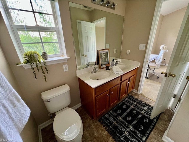 88 Tannenbaum Cir, Greensboro, NC 27410 - bathroom featuring toilet, double vanity, and baseboards