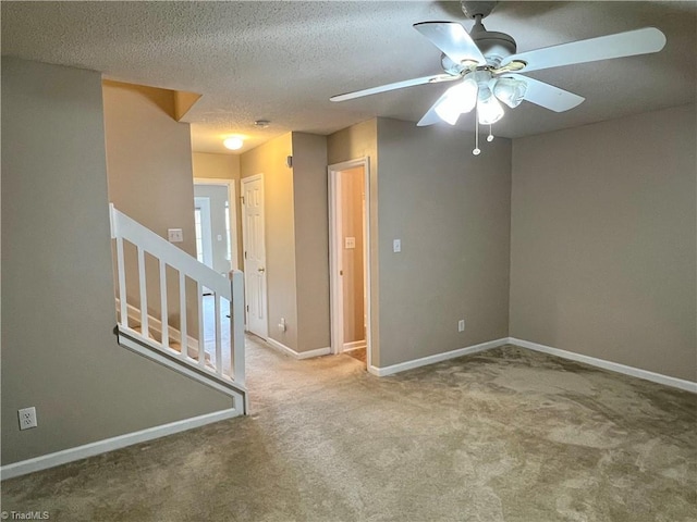 88 Tannenbaum Cir, Greensboro, NC 27410 - carpeted empty room with ceiling fan, baseboards, stairs, and a textured ceiling