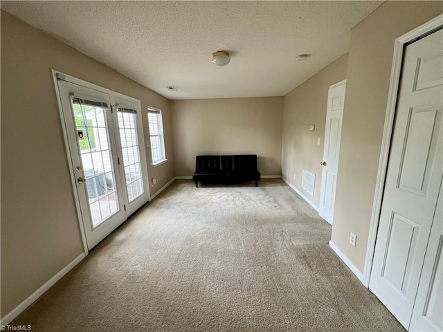 88 Tannenbaum Cir, Greensboro, NC 27410 - unfurnished room featuring light colored carpet, a textured ceiling, and baseboards