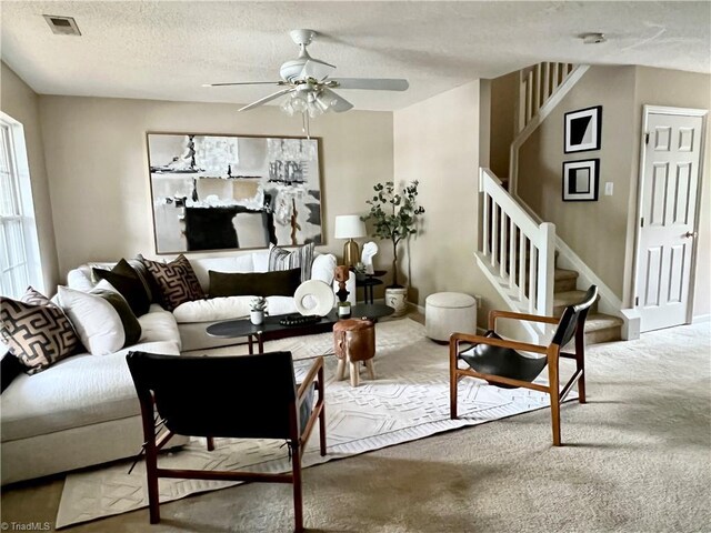 88 Tannenbaum Cir, Greensboro, NC 27410 - carpeted living room featuring ceiling fan, stairs, and a textured ceiling