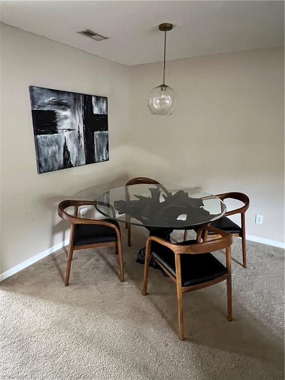 88 Tannenbaum Cir, Greensboro, NC 27410 - carpeted dining space with baseboards
