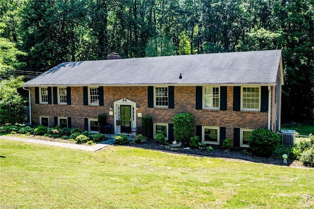 3230 Kinnamon Rd, Winston-Salem, NC 27104 - raised ranch with brick siding, a front lawn, a chimney, and central AC