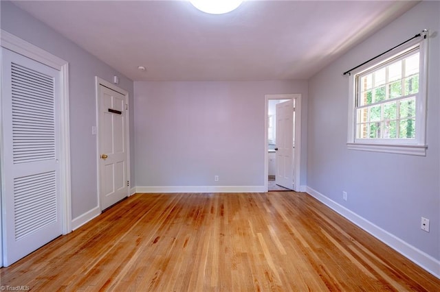 3230 Kinnamon Rd, Winston-Salem, NC 27104 - unfurnished bedroom featuring ensuite bath, light wood-style flooring, baseboards, and a closet