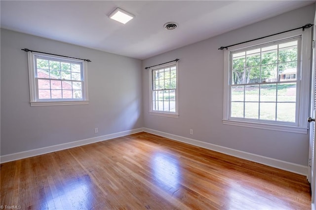 3230 Kinnamon Rd, Winston-Salem, NC 27104 - empty room with baseboards, light wood finished floors, a healthy amount of sunlight, and visible vents