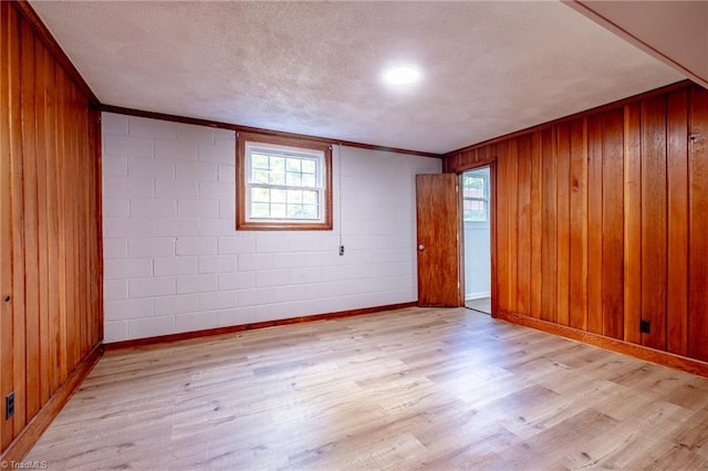 3230 Kinnamon Rd, Winston-Salem, NC 27104 - empty room featuring ornamental molding, light wood-type flooring, and wood walls