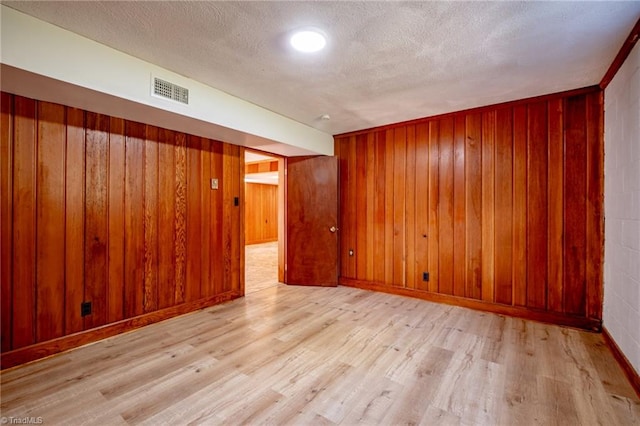 3230 Kinnamon Rd, Winston-Salem, NC 27104 - unfurnished room with visible vents, wood finished floors, and wooden walls