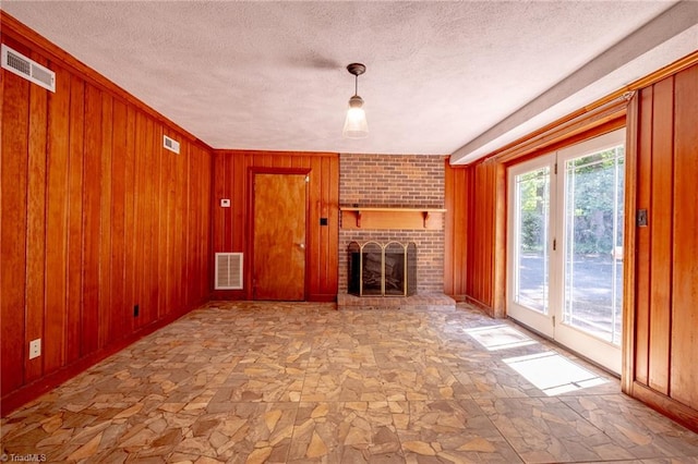 3230 Kinnamon Rd, Winston-Salem, NC 27104 - unfurnished living room with a brick fireplace, visible vents, and stone flooring