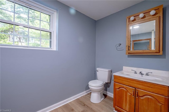 3230 Kinnamon Rd, Winston-Salem, NC 27104 - bathroom with vanity, toilet, wood finished floors, and baseboards