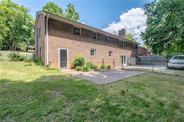 3230 Kinnamon Rd, Winston-Salem, NC 27104 - rear view of property with fence, brick siding, a chimney, a lawn, and central AC unit