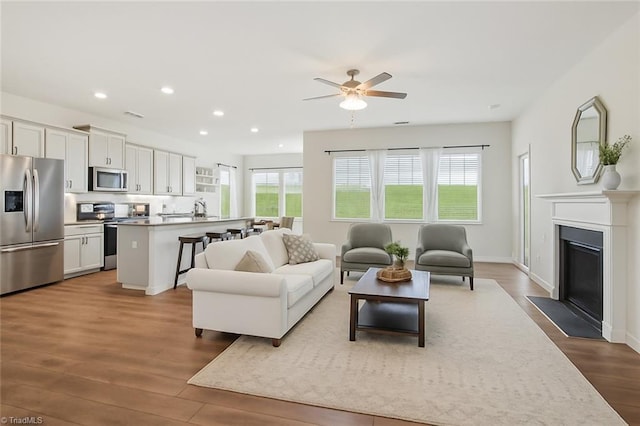 162 Bryson Blvd, Lexington, NC 27295 - living area with a ceiling fan, recessed lighting, dark wood-style flooring, and a fireplace with flush hearth