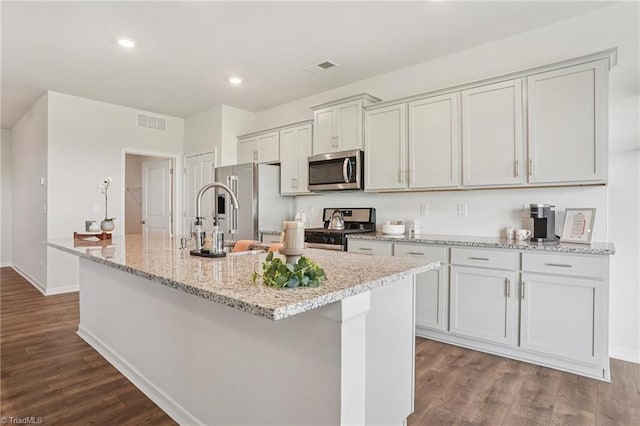 162 Bryson Blvd, Lexington, NC 27295 - kitchen with stainless steel appliances, a center island with sink, dark wood-style flooring, decorative backsplash, and recessed lighting