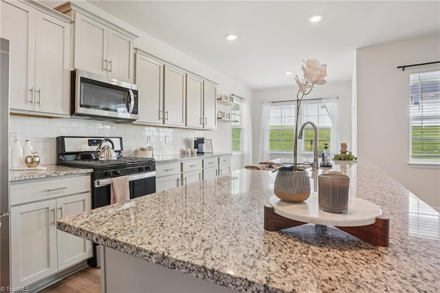 162 Bryson Blvd, Lexington, NC 27295 - kitchen featuring stainless steel appliances, healthy amount of natural light, decorative backsplash, light stone counters, and recessed lighting