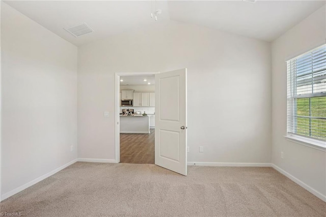 162 Bryson Blvd, Lexington, NC 27295 - unfurnished room with light carpet, vaulted ceiling, and plenty of natural light