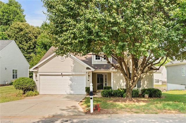 6051 Brookstone Ridge Dr, Winston-Salem, NC 27107 - view of property hidden behind natural elements featuring driveway, an attached garage, roof with shingles, and a front lawn