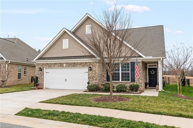 view of front of property with a front yard, driveway, a shingled roof, a garage, and brick siding