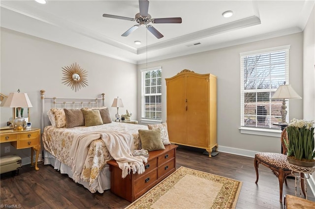 bedroom featuring multiple windows, a raised ceiling, and visible vents