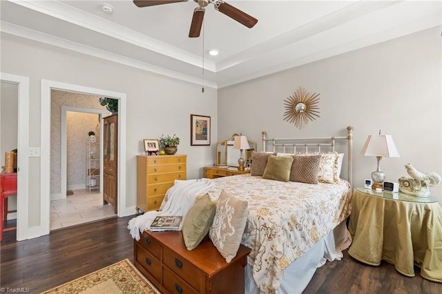 bedroom featuring wood finished floors, baseboards, recessed lighting, ornamental molding, and a raised ceiling