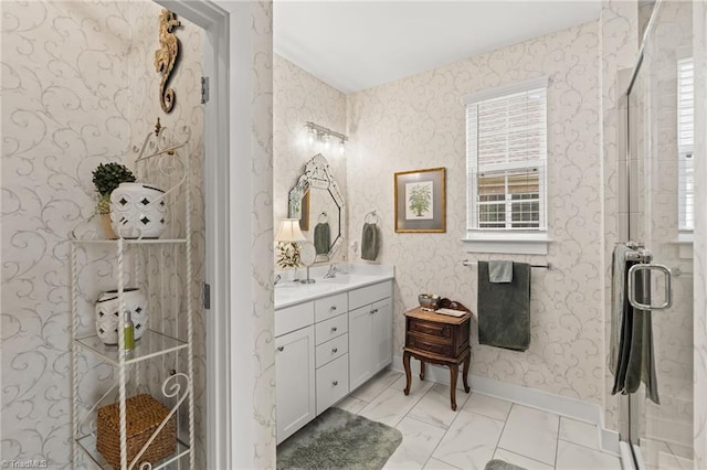 full bath with baseboards, a stall shower, vanity, and wallpapered walls