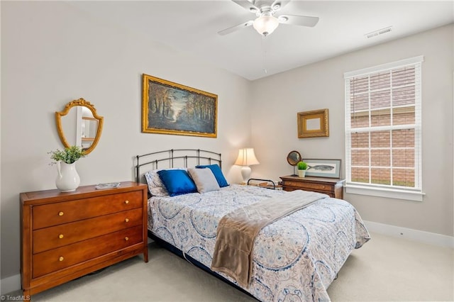 carpeted bedroom with visible vents, baseboards, and ceiling fan