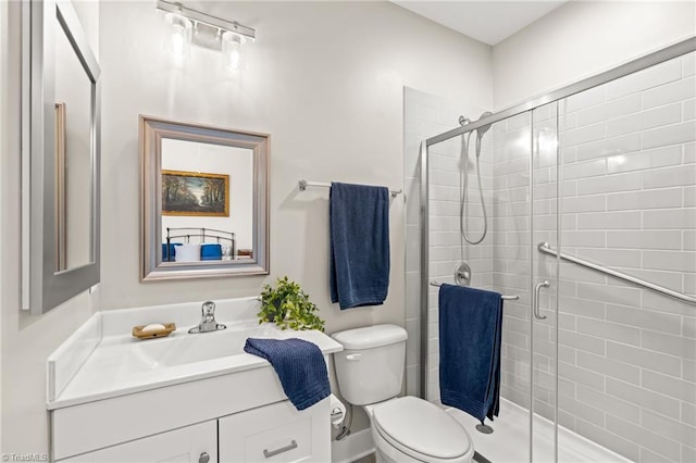 full bath featuring vanity, a shower stall, and toilet