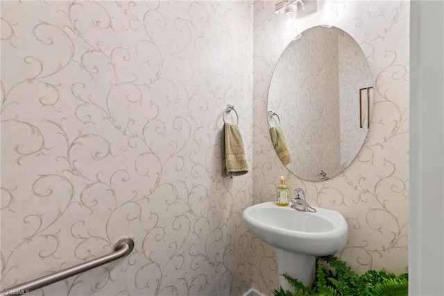 bathroom featuring wallpapered walls