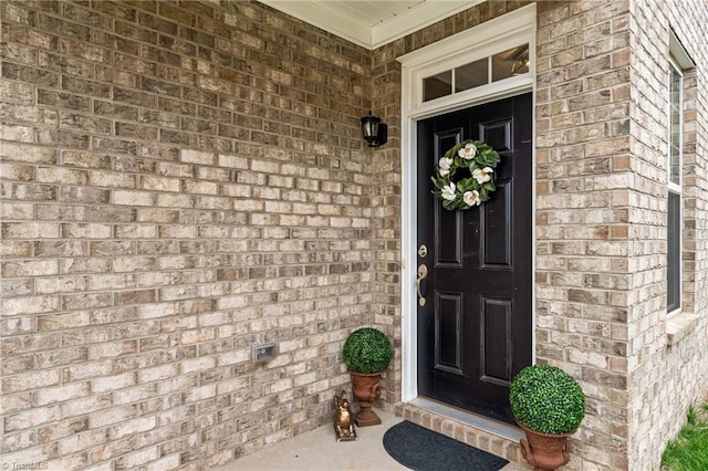 doorway to property with brick siding