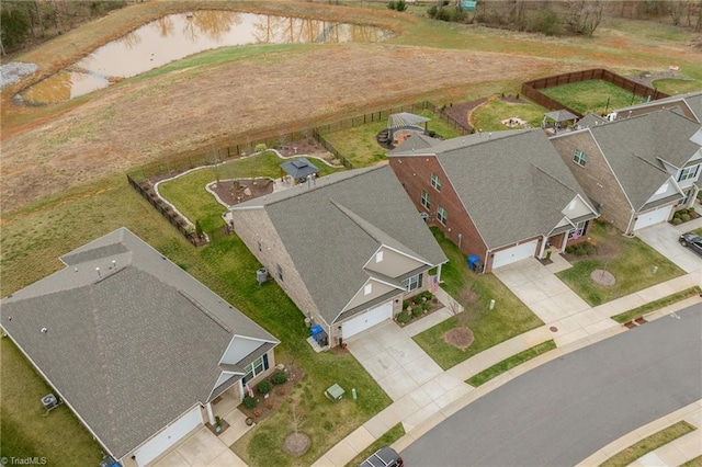 drone / aerial view with a residential view and a water view