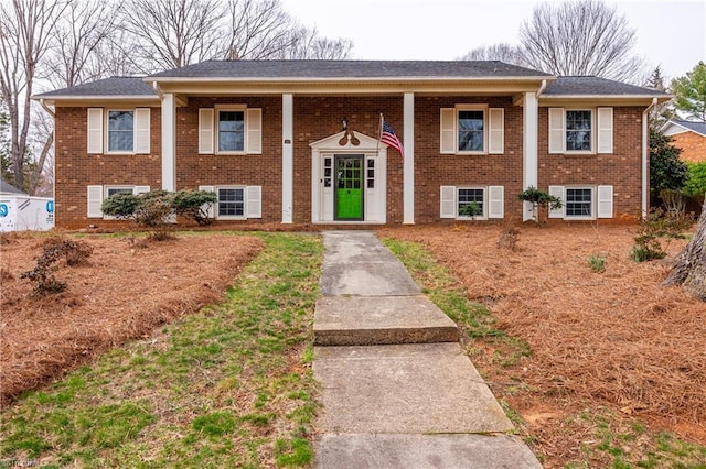 bi-level home featuring brick siding