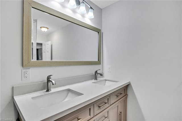 bathroom with a sink and double vanity