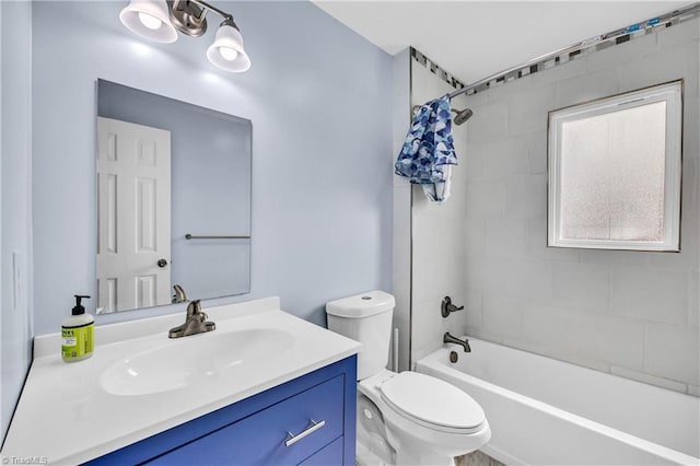 bathroom featuring vanity, bathing tub / shower combination, and toilet