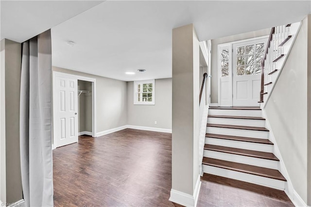 staircase with baseboards and wood finished floors