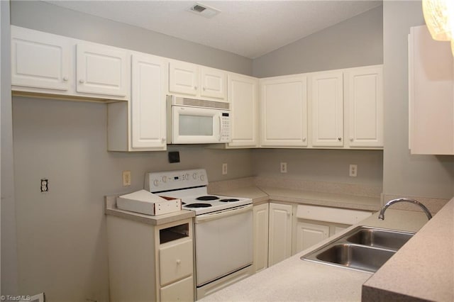 kitchen featuring white appliances, white cabinetry, and sink