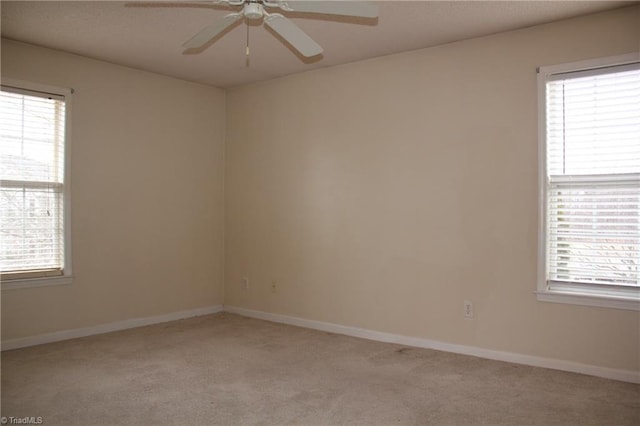 unfurnished room with ceiling fan and light colored carpet