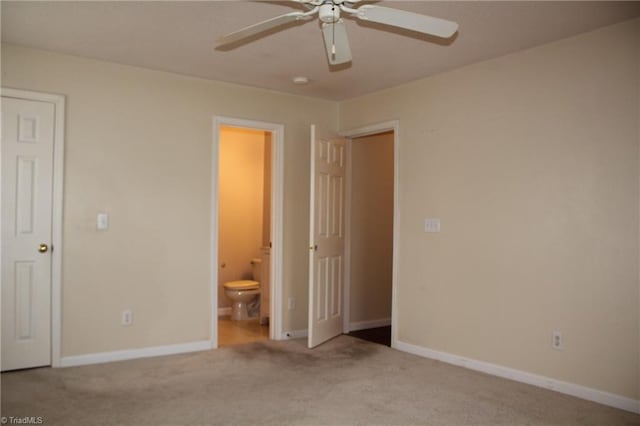 unfurnished bedroom with ceiling fan, light carpet, and connected bathroom