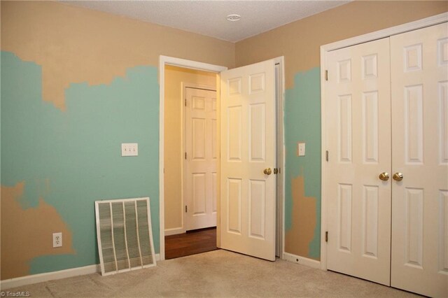 unfurnished bedroom featuring light carpet