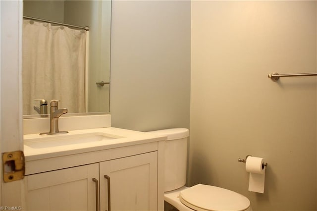 bathroom featuring toilet and vanity