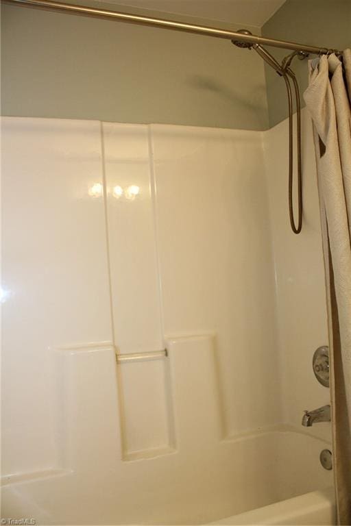 bathroom featuring shower / tub combo with curtain