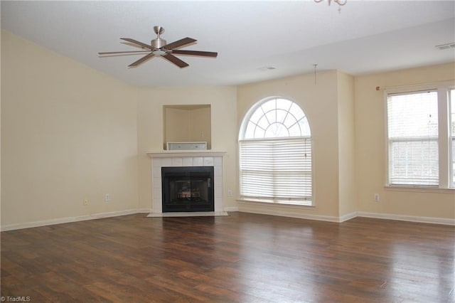 unfurnished living room featuring ceiling fan, dark hardwood / wood-style flooring, and a fireplace