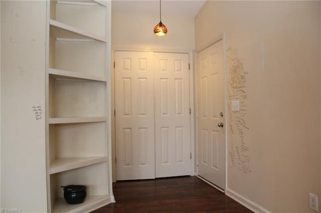 corridor featuring dark hardwood / wood-style flooring