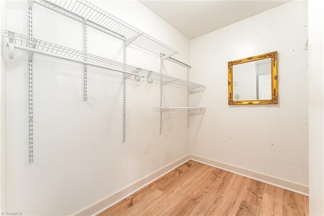 spacious closet with wood finished floors