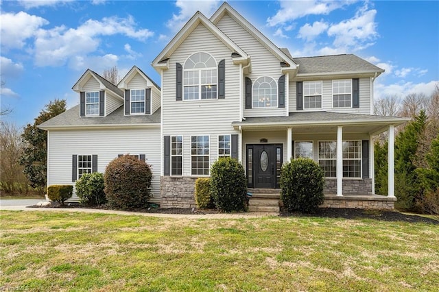 view of front of property featuring stone siding, a porch, and a front lawn