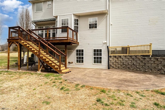 rear view of house with a patio, stairway, and a wooden deck