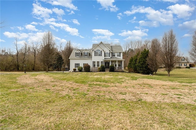 view of front of property featuring a front lawn and a porch