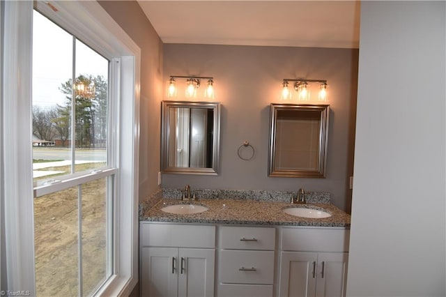 bathroom with a sink and double vanity